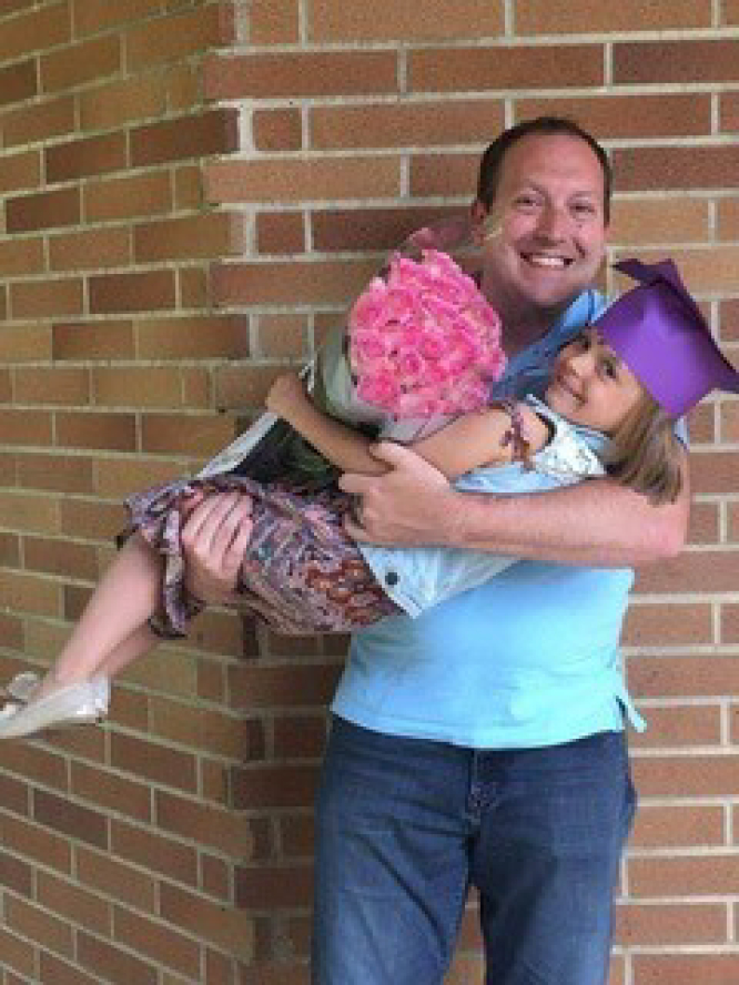 Camas School Board director Corey McEnry hugs his daughter, Molly, a fourth-grader at Helen Baller Elementary School.