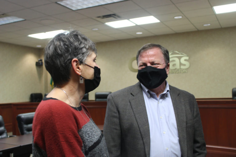 Former Camas interim mayor Ellen Burton (left) gathers with the city&#039;s new mayor, Steve Hogan (right), in Camas City Hall following Hogan&#039;s swearing-in ceremony on Tuesday, Nov. 23, 2021.