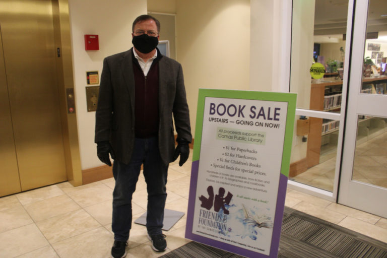 Camas Mayor Steve Hogan visits the Camas library's annual book sale during the city of Camas' 2021 Hometown Holidays event on Friday, Dec.