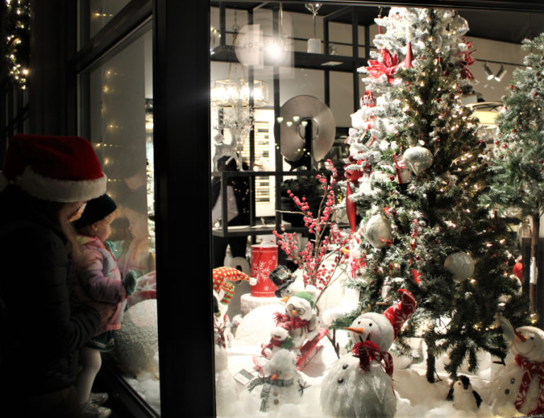 A family admires holiday displays inside the Juxtaposition home furnishings shop in downtown Camas during the city of Camas’ 2021 Hometown Holidays event on Friday, Dec. 3, 2021. (Kelly Moyer/Post-Record)