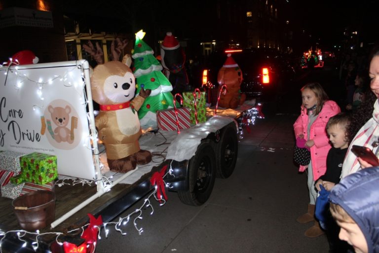 Children greet a lighted vehicle during the Washougal Lighted Christmas Parade on Thursday, Dec 2, 2021. (Doug Flanagan/Post-Record)