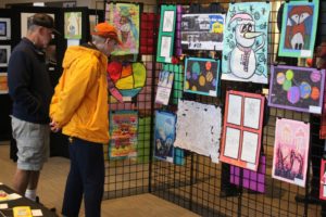 Attendees look at student artwork during the 2022 Washougal Youth Arts Month gallery exhibit at Washougal High School on Wednesday, March 23, 2022. (Doug Flanagan/Post-Record files)