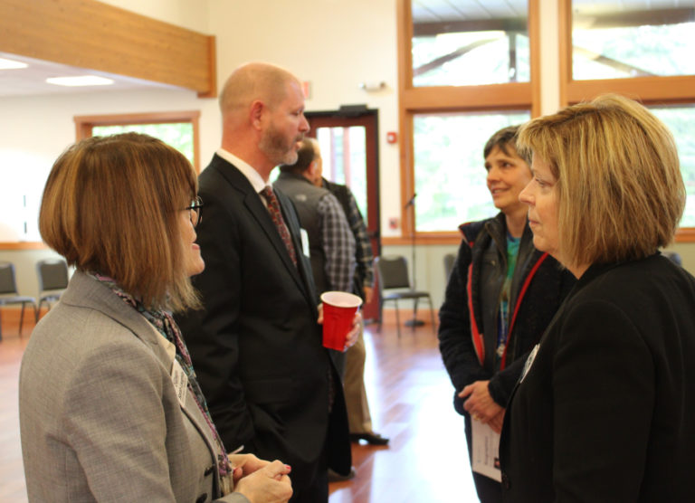 Jeff Niten (second from left), the city manager for the city of Shelton, Wash., and one of four finalists vying to be the city of Camas’ next city administrator, speaks to former Camas mayor Ellen Burton (second from right) as Camas City Council member Shannon Roberts (right) mingles with community members during a meet-and-greet event at Lacamas Lake Lodge on Thursday, May 12, 2022.