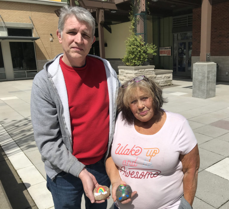 Washougal residents Rich Beck and Kathy Dering hold two of the rocks that will go into the Washougal Children's Rock Garden, the city's first interactive art installation created by children, on Saturday, May 14.