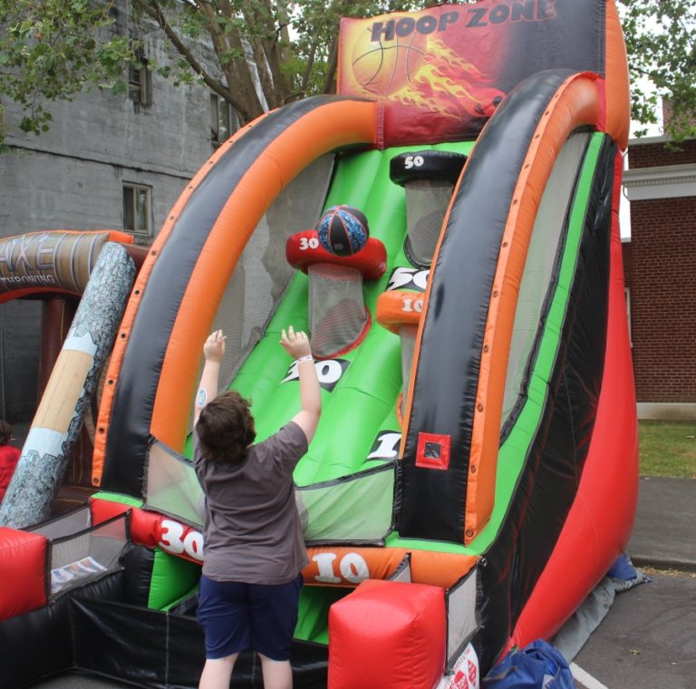 A youngster shoots a basketball at the 2022 Camas Days "Kids Street" in downtown Camas Saturday, July 23, 2022.
