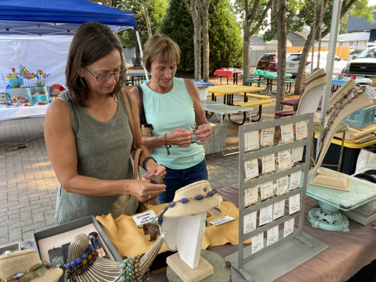 Event-goers look at pieces of art during the 2021 Washougal Art Festival.