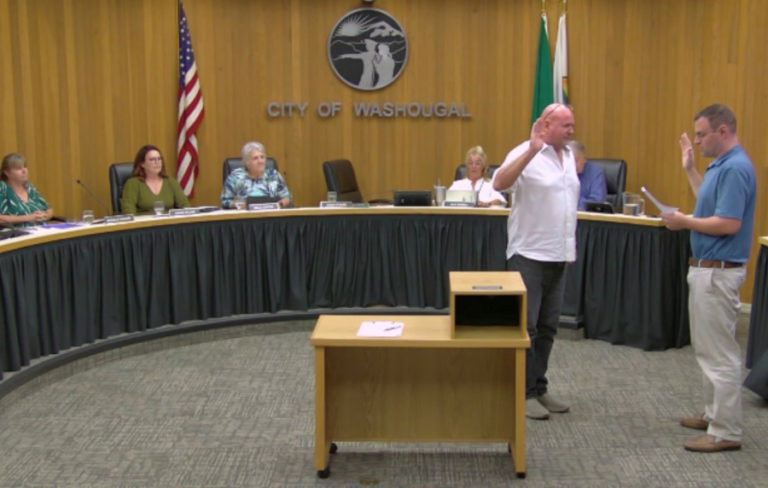 Washougal Finance Director Daniel Layer (right) swears in newly appointed Washougal Mayor David Stuebe (second from right) during a Washougal City Council meeting on Monday, Sept. 26, 2022.