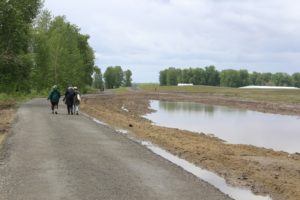 Visitors walk down a path at Steigerwald Lake National Wildlife Refuge in Washougal on Saturday, May 7, 2022. (Doug Flanagan/Post-Record files)