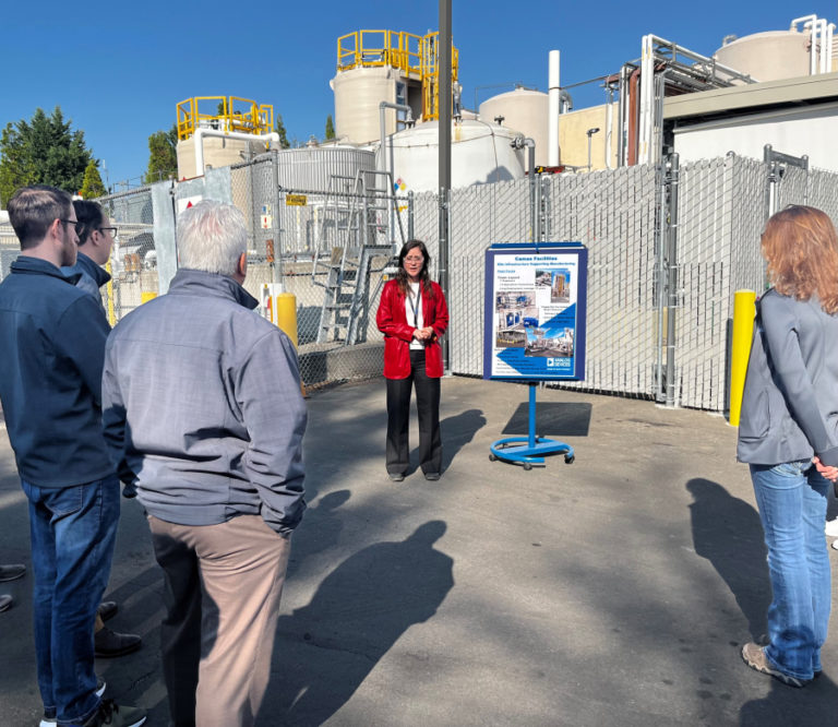 Elizabeth Rupp (center), an Analog Devices employee, points out new equipment during a tour of the Camas wafer fabrication plant on Monday, Oct. 10, 2022.