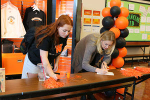 Washougal High School marketing student Samantha Mcray-Smith (left) and business teacher Nicole Simek process orders at the Washougal Co student store in November. (Contributed photo courtesy Washougal School District)