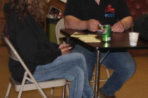 Recovery Cafe Clark County recovery coach supervisor Ethan Gonzales (right) talks with a woman in the Washougal-based Recovery Cafe on Monday, April 18, 2022. (Doug Flanagan/Post-Record files)