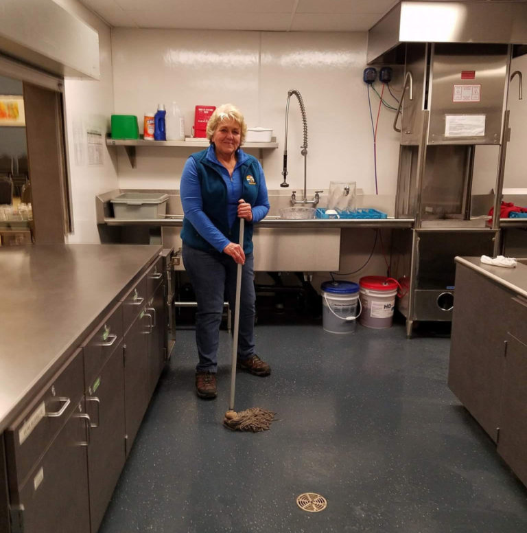 Washougal City Councilwoman and former Mayor Molly Coston cleans the Washougal Community Center's kitchen after a ReFuel Washougal weekly meal.