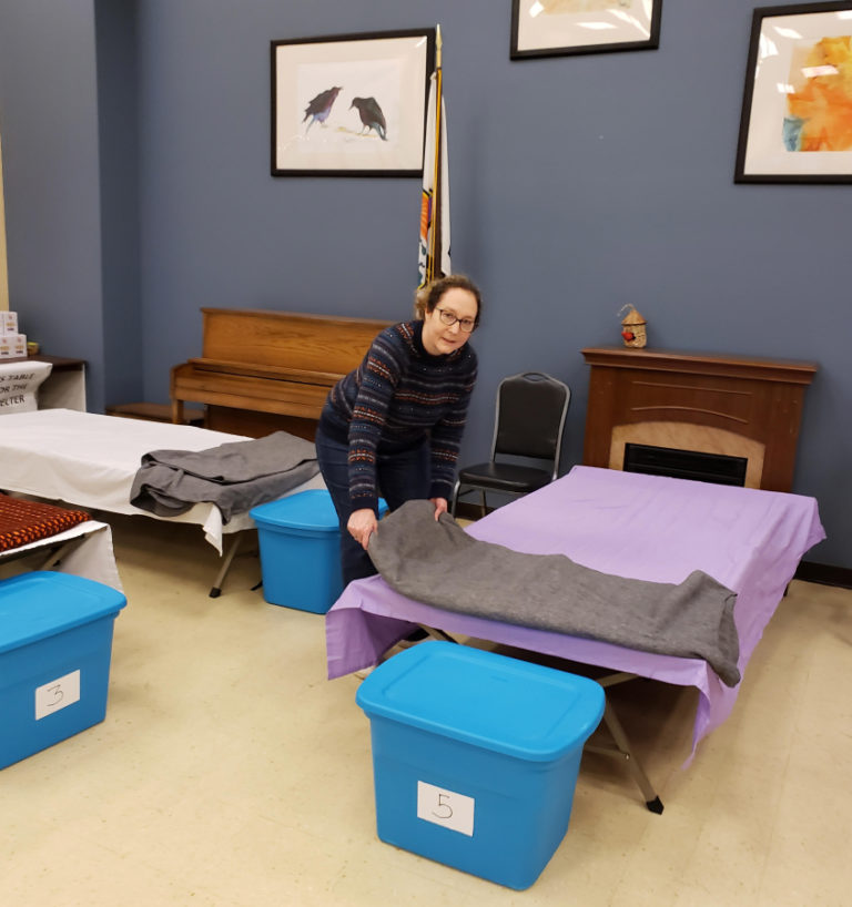 ReFuel Washougal volunteer Lynette Kamakura makes a bed at the nonprofit organization's severe weather shelter at the Washougal Community Center earlier this year.