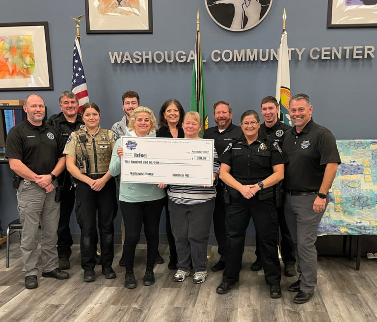 Contributed photo courtesy of ReFuel Washougal 
 ReFuel Washougal recently received a "kindness citation" and $500 from Kindness 911, a Clark Count-based nonprofit organization. Ann Stevens (fifth from left) recently took over as ReFuel's board chair, replacing Robert Barber.