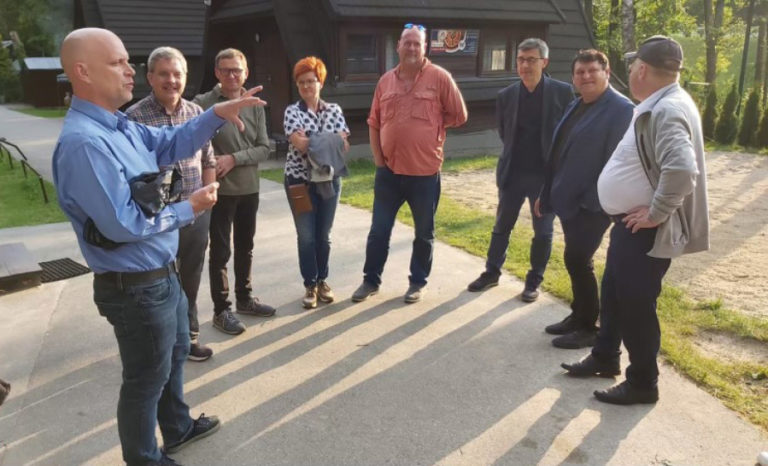 Contributed photo courtesy city of Zielonki, Poland 
 Zielonki, Poland, resident David Toft (far left) speaks to Washougal city manager David Scott (second from left), Washougal Mayor David Stuebe (fourth from right) and Zielonki officials during a visit to a Scout Camp and adjacent community center, which previously served as a Ukrainian refuge center, in June.