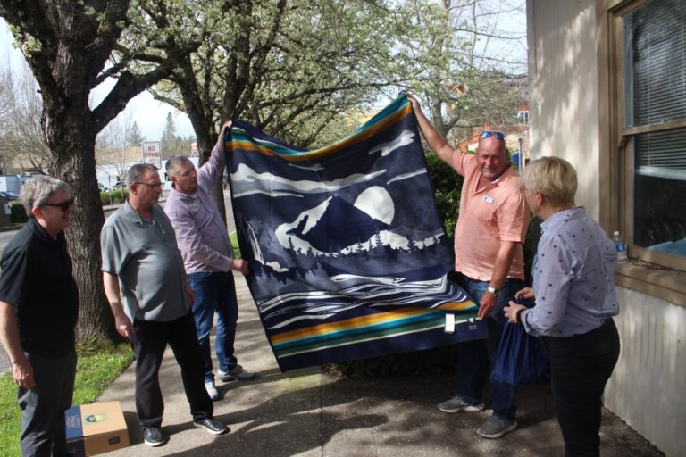 Washougal Mayor David Stuebe (second from right) presents Roma Toft (far right), a city council member in Zielonki, Poland, with a Pendleton Woolen Mills blanket in Washougal on Wednesday, April 19, 2023.