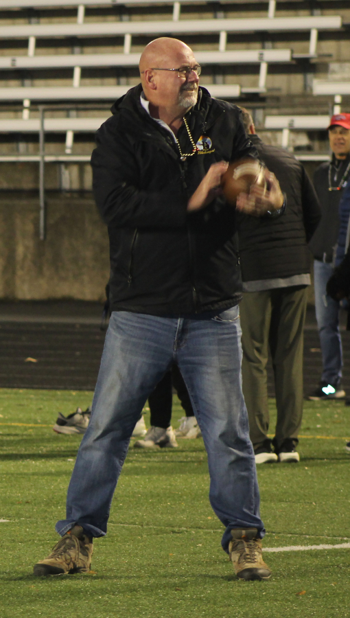 Washougal Mayor David Stuebe catches a football before the start of the Camas-Washougal Salvation Army's 