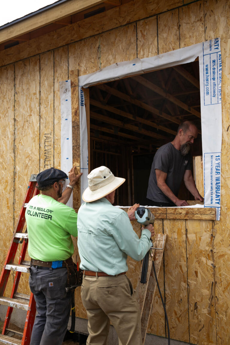 Volunteers work on an Evergreen Habitat for Humanity house project at the Johnson Village subdivision in Vancouver in 2024.
