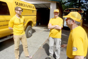 Silver Star Search and rescue medical officer Jeff Berner (left) board member Tom Nichols (center) and rescue coordinator Rick Blevins talk in front of East County Fire and Rescue’s Station 92, May 13, 2024.