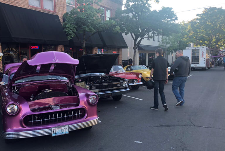Visitors inspect classic cars at the Camas Car Show in downtown Camas, June 29, 2019.