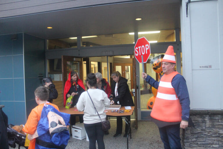 Doug Flanagan/Post-Record
Washougal City Councilman David Fritz (right), dressed as a safety cone “directs traffic” in the front of Washougal City Hall during the Washougal Trick or Treat on Main Street event on Oct. 31, 2024.