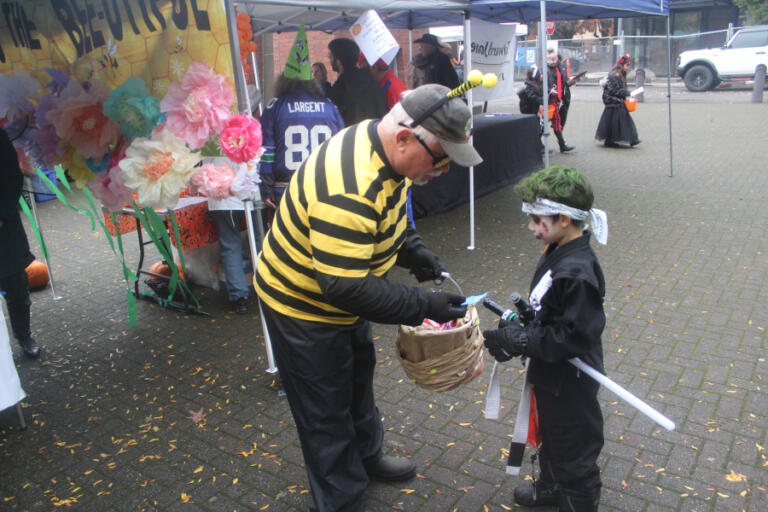 Doug Flanagan/Post-Record
A child receives candy during the Washougal Trick or Treat on Main Street event on Oct. 31, 2024.