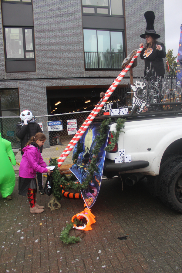 Doug Flanagan/Post-Record
A child receives candy, sliding down a “candy cane,” during the Washougal Trick or Treat on Main Street event on Oct. 31, 2024.