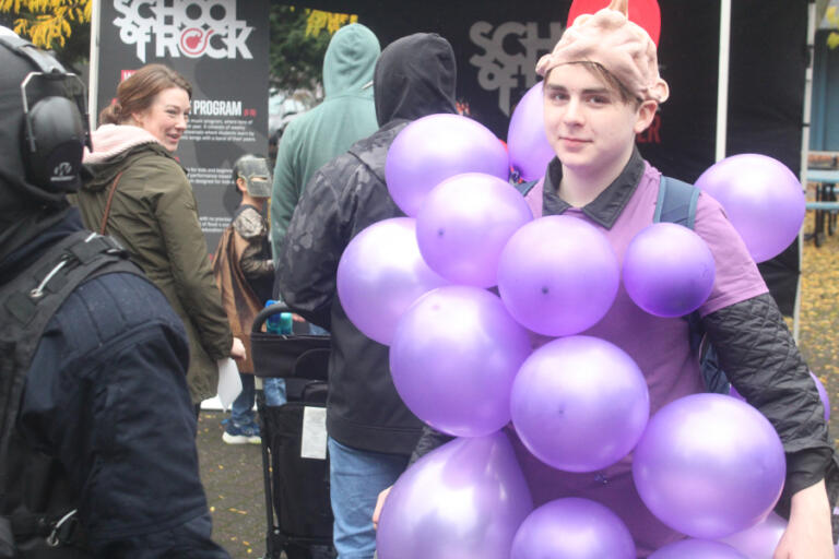 Doug Flanagan/Post-Record
A bunch of grapes walks through Reflection Plaza during the Washougal Trick or Treat on Main Street event on Oct. 31, 2024.