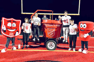 Camas High School football players Ryan Criddle, Jake Davidson, Jaxon Goode and Titan Brodie pose for a photo after winning the 2024 Camas-Washougal Salvation Army Red Kettle Kickoff on Nov. 25, 2024.