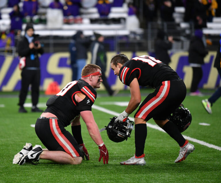 Camas senior Beau Harlan, right, consoles Camas senior Luke Webb on Saturday, Dec. 7, 2024, after the Papermakers’ 27-24 loss to Sumner in the 4A State Championship game at Husky Stadium.