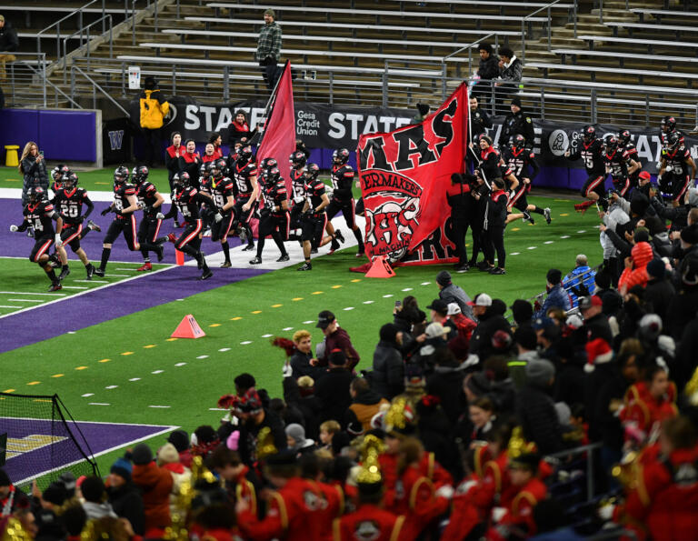 Camas players take the field in the second half Saturday, Dec. 7, 2024, during the Papermakers’ 27-24 loss to Sumner in the 4A State Championship game at Husky Stadium.