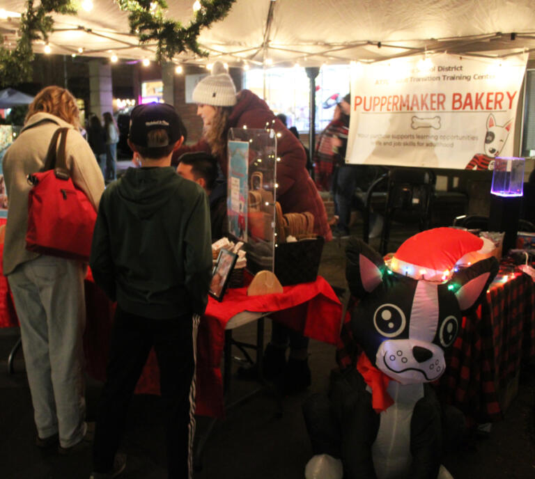 Customers purchase dog treats made by the Camas School District's "Puppermaker Bakery" during the 2024 Hometown Holidays event, Friday, Dec. 6, 2024.