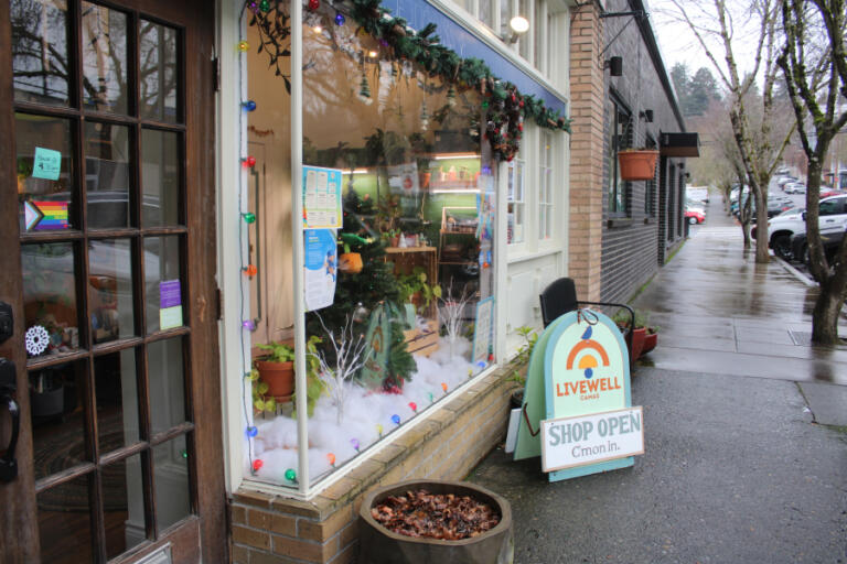 A "Shop Open" sign sits outside LiveWell Camas on Thursday, Dec. 12, 2024. The yoga-fitness studio and community gathering space recently converted from a limited liability corporation to a nonprofit. Founder Jacquie Michelle Hill hopes the new nonprofit status will help her return to her original goal of offering affordable and accessible yoga, movement and wellness classes to the Camas-area community, regardless of age, income or ability.