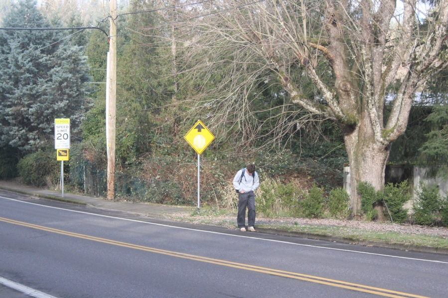 A Washougal High School student walks south along the shoulder of 39th Street in Washougal on Jan. 17, 2025.
