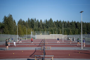The Camas girls tennis team practices Friday at Camas High School. The Camas School District has plans to partner with the U.S. Tennis Association to build a solid fabric “bubble” over its outdoor Camas High tennis courts and open the courts to paying members of the public, a plan Camas athletic leaders say will help the Camas girls tennis team avoid rained-out practices and matches. (Taylor Balkom/The Columbian)
