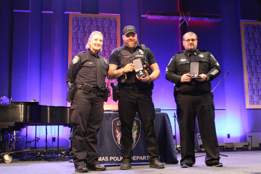 Camas Police Chief Tina Jones, left, presents Medals of Merit awards to Camas police Officer Ward Kruse, center, and Washougal police Sgt. Thad Eakins, right, at Grace Foursquare Church in Camas on May 23, 2024. (Kelly Moyer/Post-Record files)