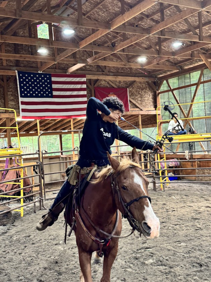 Washougal resident Enzo Lavasseur aims an arrow while riding his horse, Tecumsah, on Sept.