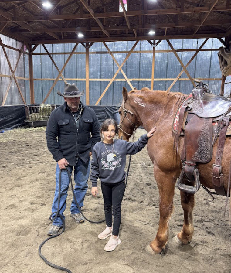 Washougal resident Randy Lavasseur and his daughter, Lilliana Lavasseur, 10, pose for a photo with their horse on Nov. 26, 2024.