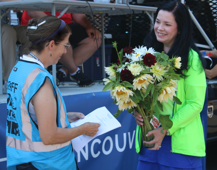 Camas-Washougal Chamber of Commerce Executive Director Jennifer Senescu, right, honors Camas Parks and Recreation’s special events coordinator, Krista Bashaw, during the 2024 Camas Days celebration on July 26, 2024. Bashaw is retiring this month after 30 years working for the city. (Kelly Moyer/Post-Record files)