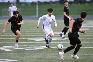 Columbia River senior JP Guzman (10) moves between Camas defenders during Monday’s non-league match at Doc Harris Stadium. (Photos by Taylor Balkom/The Columbian)