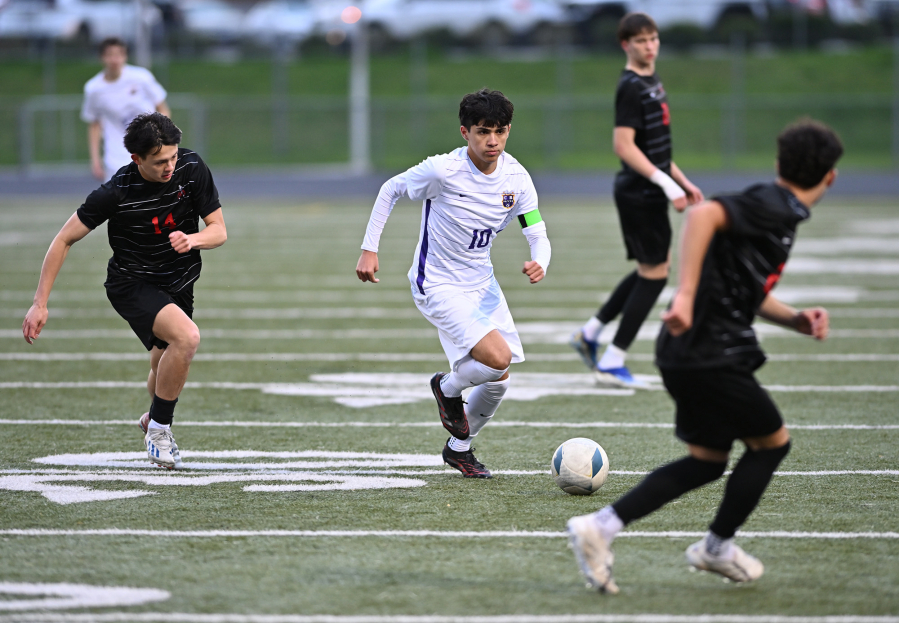Columbia River senior JP Guzman (10) moves between Camas defenders during Monday’s non-league match at Doc Harris Stadium. (Photos by Taylor Balkom/The Columbian)