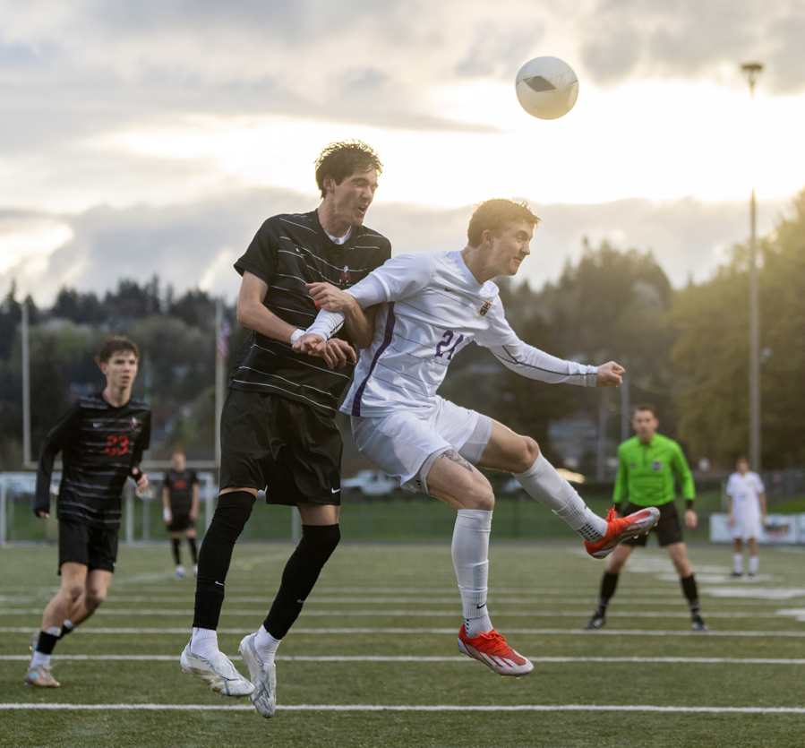 Camas’ Luke Manandic, left, and Columbia River’s Tyler Brown go for headers during the teams first match against each other since 2019.