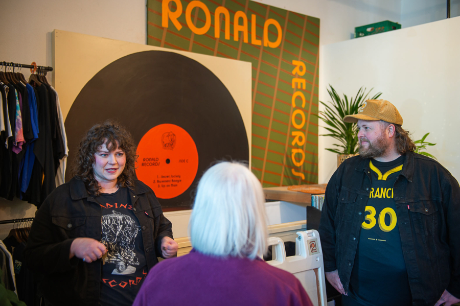 U.S. Sen. Patty Murray, D-Wash., center, talks with Jon and Kelsey Jennings, owners of Ronald Records in downtown Vancouver, about supply disruptions and materials prices affected by the Trump administration’s tariffs during a Thursday visit. (James Rexroad/for The Columbian)