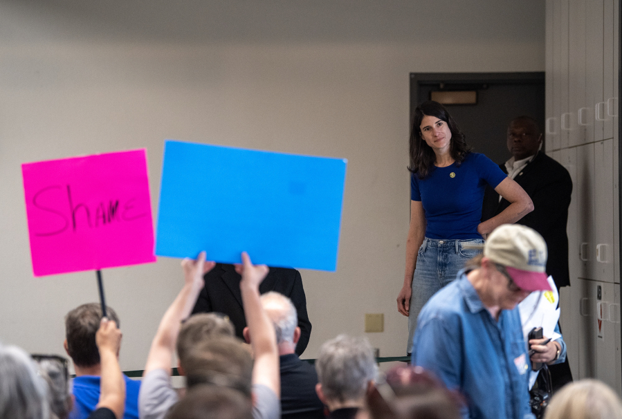 U.S. Rep. Marie Gluesenkamp Perez, D-Skamania, walks on stage to boos and sign-waving Thursday, April 24, 2025, during a town hall at the Luepke Center in central Vancouver. (Photos by Taylor Balkom/The Columbian)