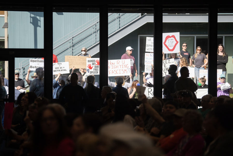 People who could not fit inside gather outside to protest Thursday during a town hall with U.S. Rep. Marie Gluesenkamp Perez, D-Skamania, at the Luepke Center in central Vancouver. (Taylor Balkom/The Columbian)
