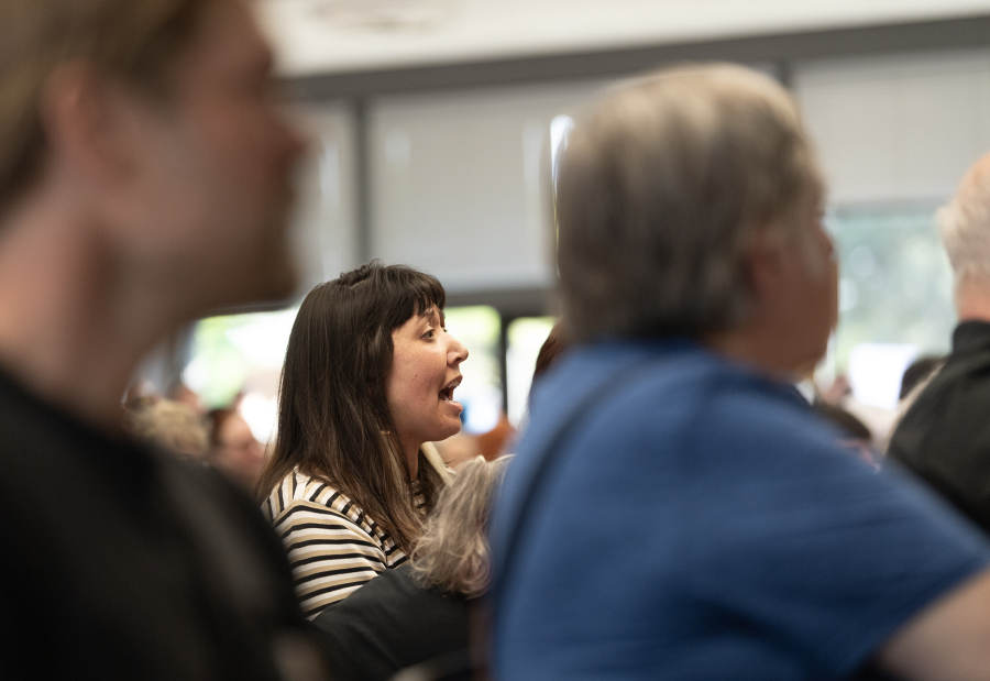 At right: An audience member shouts at Perez during Thursday’s event.