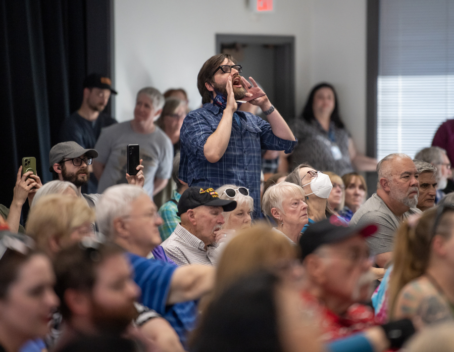 An audience members yells Thursday during a town hall with U.S. Rep. Marie Gluesenkamp Perez, D-Skamania, at the Luepke Center in central Vancouver. (Taylor Balkom/The Columbian)