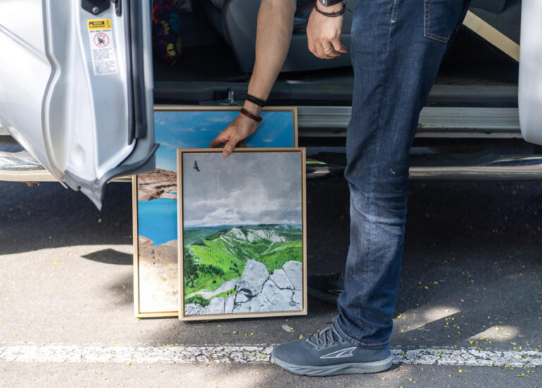 Artist Travis London gets artwork out of his car ahead of his May show at the Second Story Gallery in Camas on Friday at the Camas Public Library.