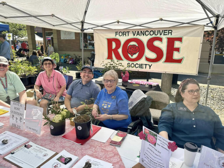 Members of the Fort Vancouver Rose Society sit at a vendor table during a past Camas Plant and Garden Fair. This year&rsquo;s fair will be held from 9 a.m. to 4 p.m. Saturday, May 10 in downtown Camas.