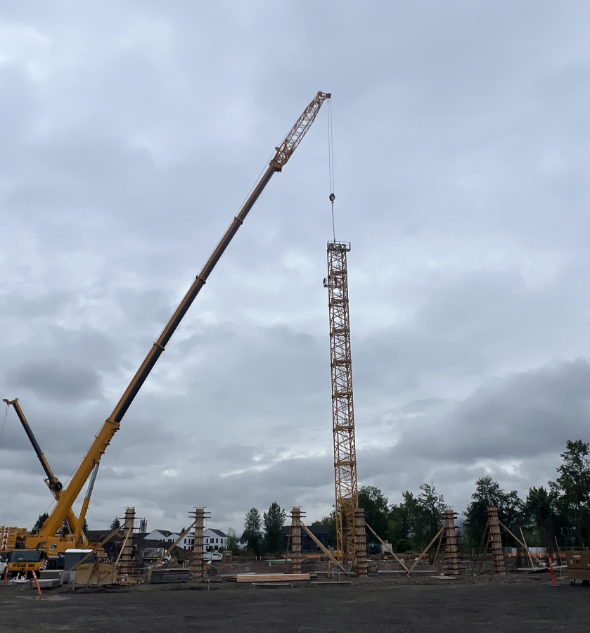 Construction crews install a tower crane near the Washougal waterfront, on the site of the future Hyas Point mixed-use development, May 13. (Contributed by Central Bethany Construction)